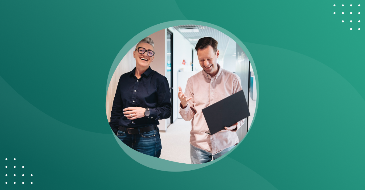 Photo of two people walking in a office