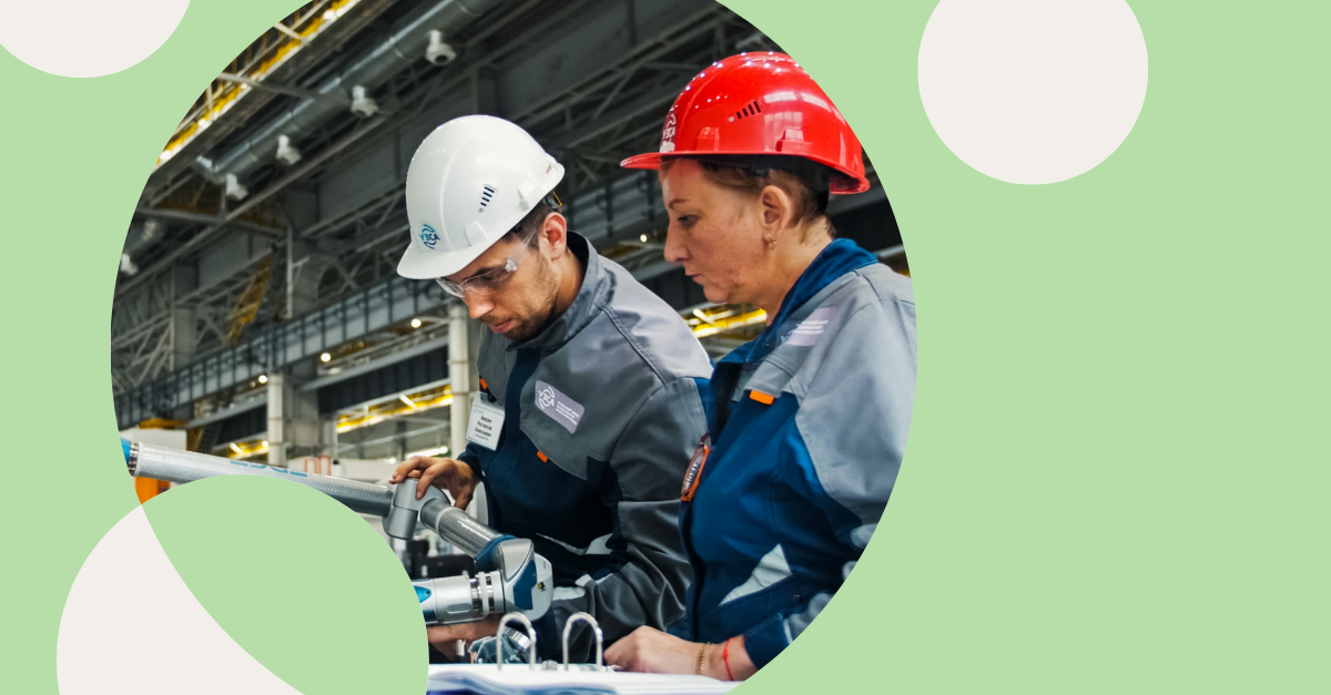 Picture of two people working in a factory