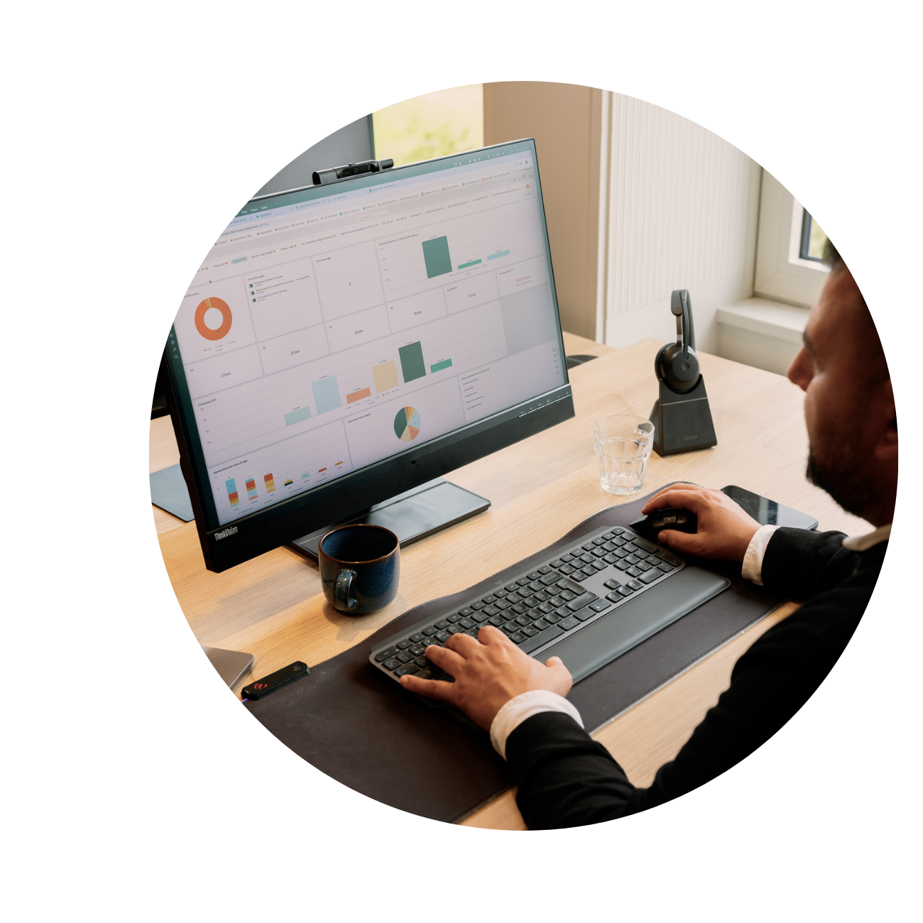 Picture of man sitting in front of a computer in the office