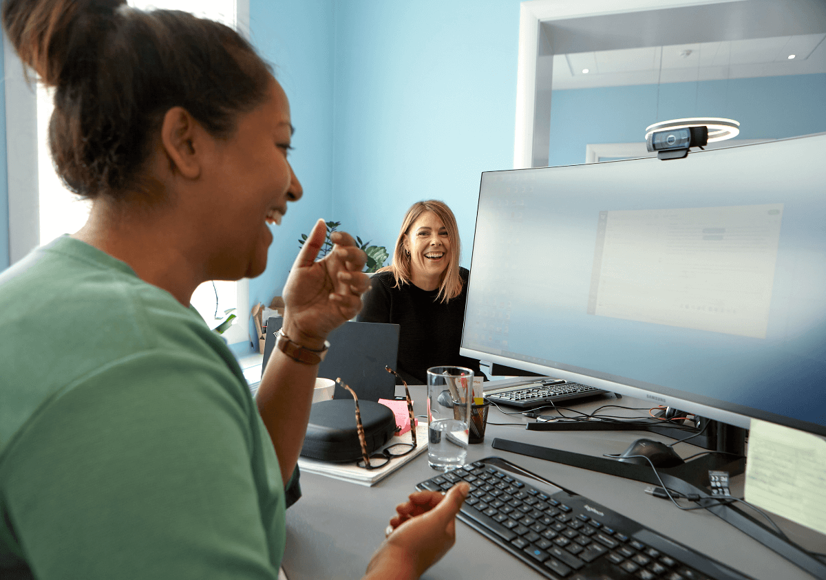 Two smiling woman at the office