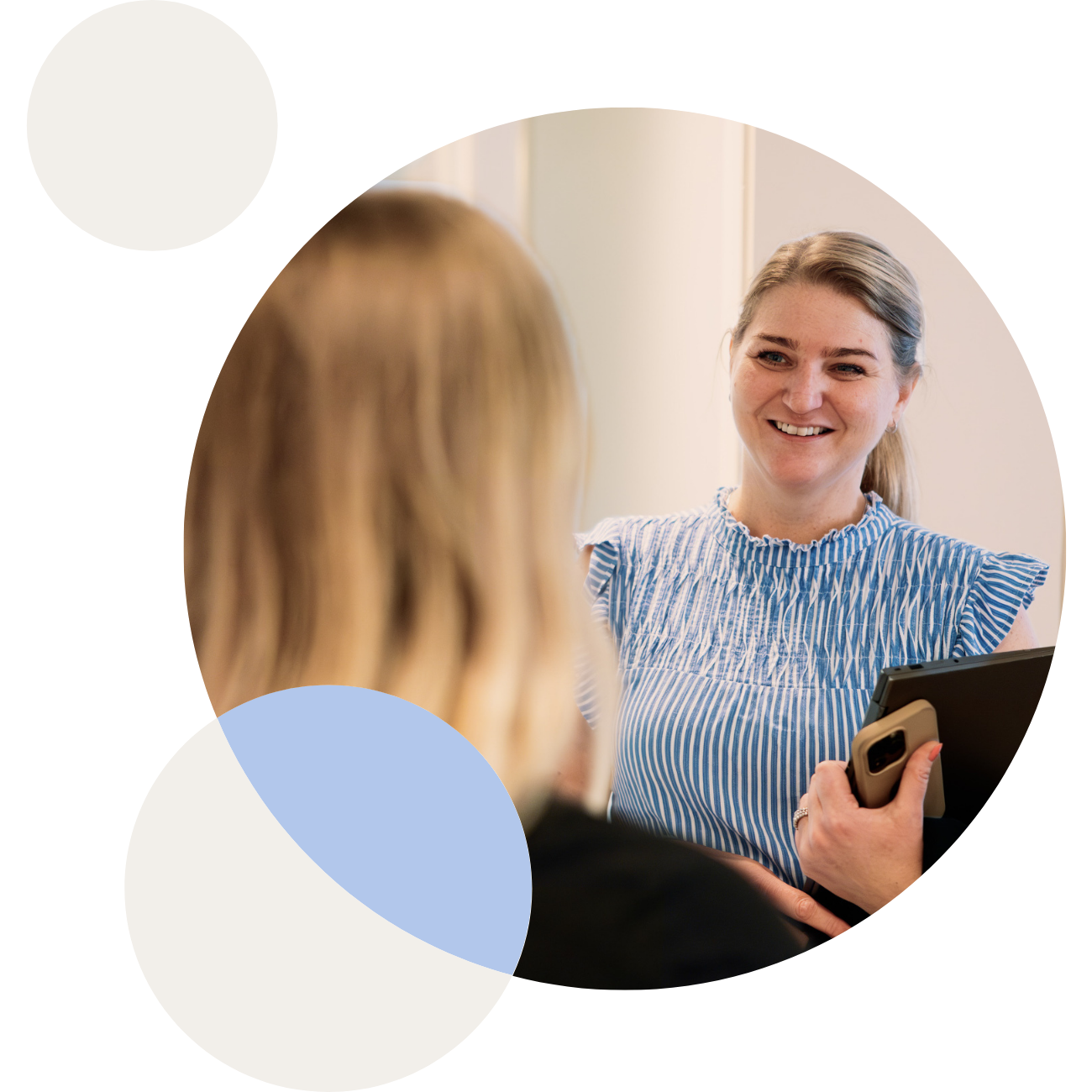 Two woman looking at a floorplan on a Ipad