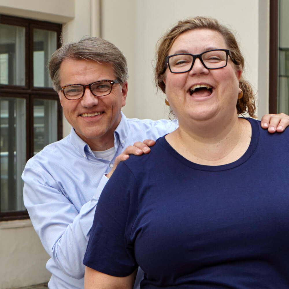 Smiling man and woman in the office