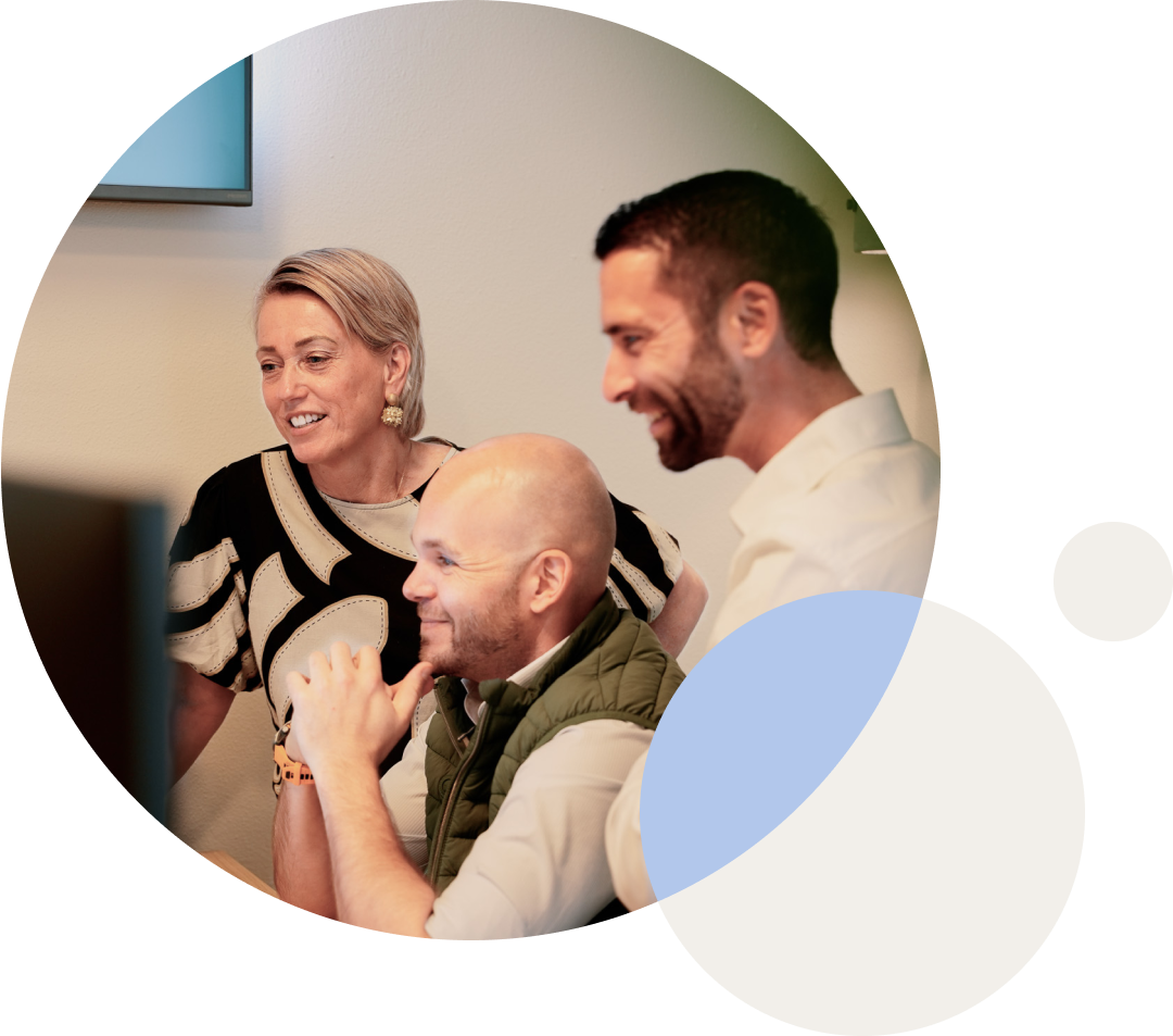 Three colleagues looking at a screen together