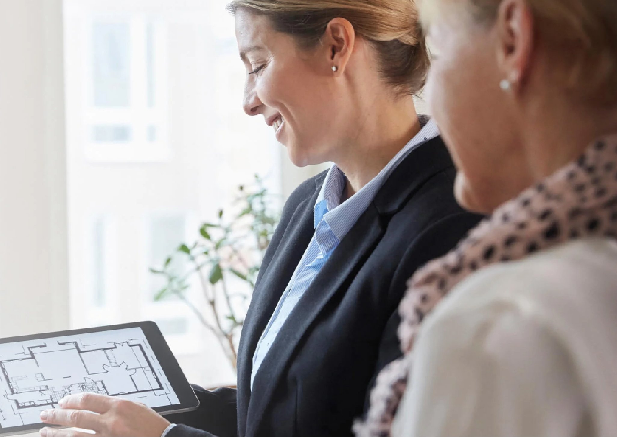 Two woman looking at a floorplan on a Ipad